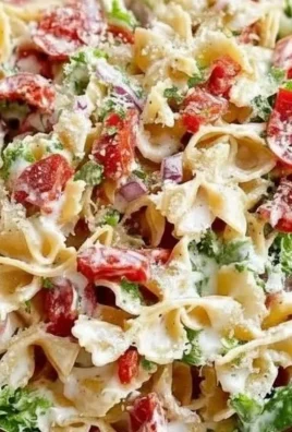 A bowl of BLT Pasta Salad with bacon, lettuce, and tomatoes, perfect for summer meals.