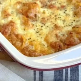 Cheesy baked tortellini casserole topped with meat sauce and cheese