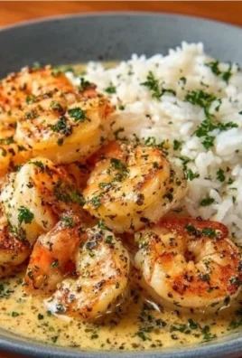 Creamy garlic butter shrimp dish with rice on a plate