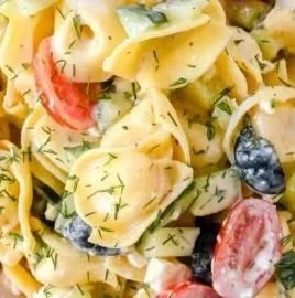 Creamy Greek Tortellini Pasta Salad with olives, feta cheese, and fresh vegetables