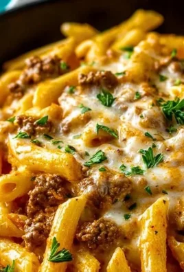 Creamy high protein beef pasta dish served in a bowl with garnishes.