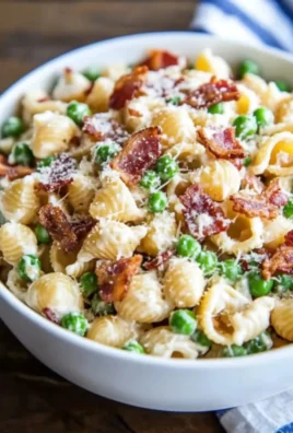 Creamy pasta salad served in a bowl with colorful vegetables and dressing