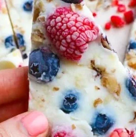 Homemade frozen yogurt bark topped with fruits and nuts.
