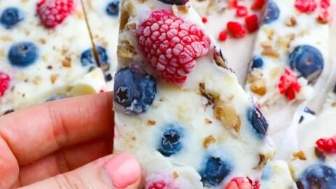 Homemade frozen yogurt bark topped with fruits and nuts.