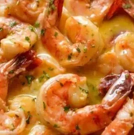 Delicious Garlic Butter Shrimp served with herbs and lemon