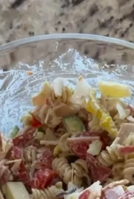 A vibrant bowl of Grinder Pasta Salad with colorful vegetables.