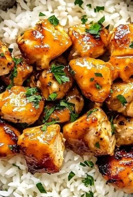 Delicious Hot Honey Chicken Bowls topped with fresh vegetables and sauce