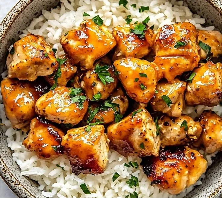 Delicious Hot Honey Chicken Bowls topped with fresh vegetables and sauce