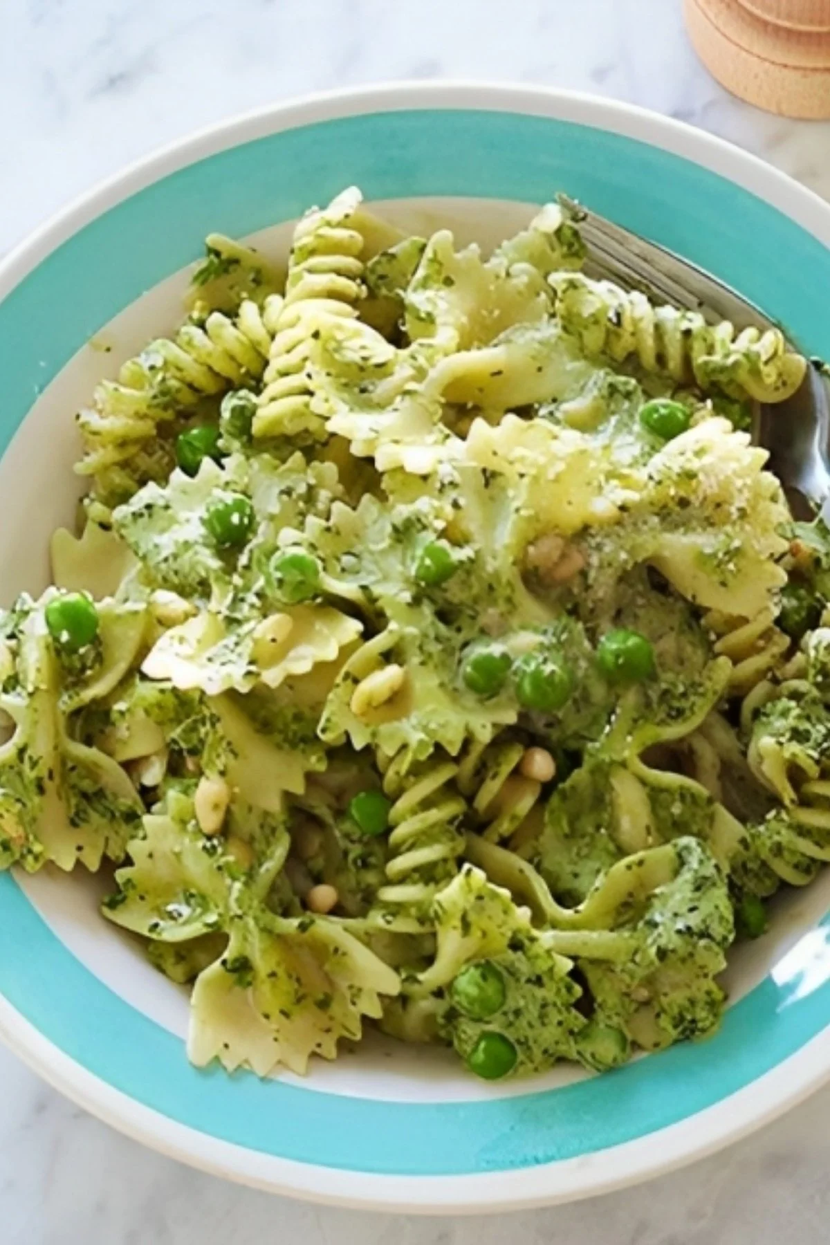 Ina Garten's pesto pasta salad with fresh ingredients and vibrant colors