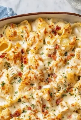 Irresistible Crack Chicken Casserole topped with cheese and herbs in a baking dish