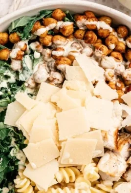 Bowl of Kale Caesar Pasta Salad with fresh ingredients and creamy dressing