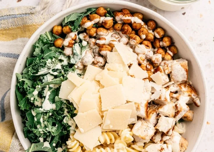 Bowl of Kale Caesar Pasta Salad with fresh ingredients and creamy dressing