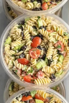 Mediterranean protein pasta salad loaded with vegetables and vibrant colors.