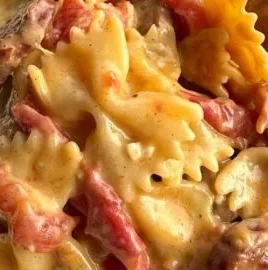 Creamy Cajun Sausage Pasta served in a bowl with fresh herbs and spices.
