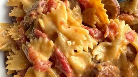 Creamy Cajun Sausage Pasta served in a bowl with fresh herbs and spices.