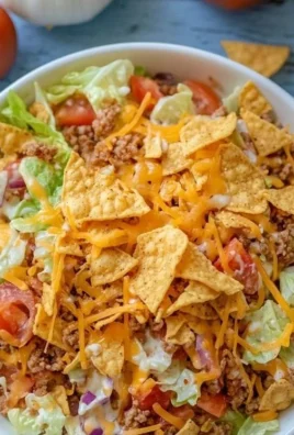 Colorful bowl of Simple Doritos Taco Salad topped with fresh ingredients and Doritos