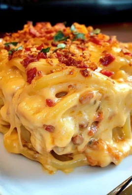 Delicious spicy Southern cheesy chicken spaghetti casserole topped with cheese.