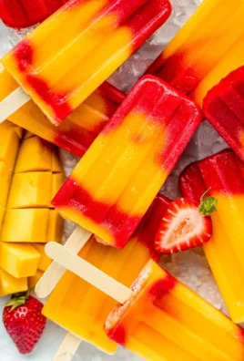 Homemade Strawberry Mango Popsicles with fresh fruit and vibrant colors