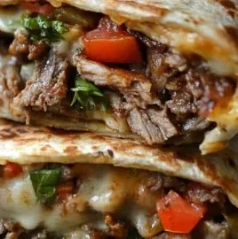Crispy grilled wraps filled with Philly cheesesteak ingredients