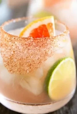 A refreshing Easy Paloma cocktail garnished with lime and served in a glass.