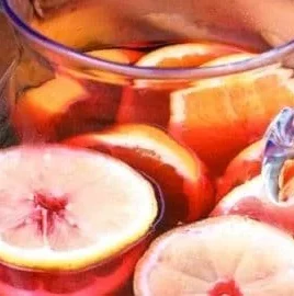 A glass of refreshing Hibiscus Water garnished with hibiscus flowers