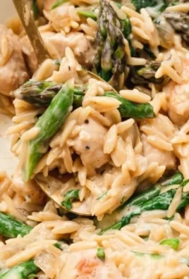 High protein chicken orzo dish garnished with herbs