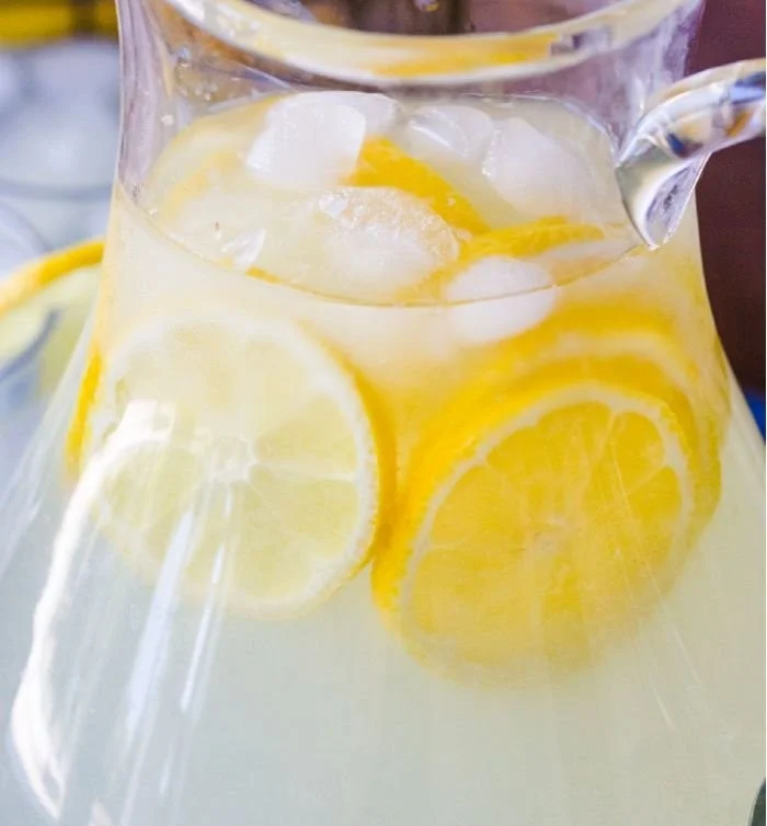 Glass of refreshing homemade lemonade with lemon slices and ice