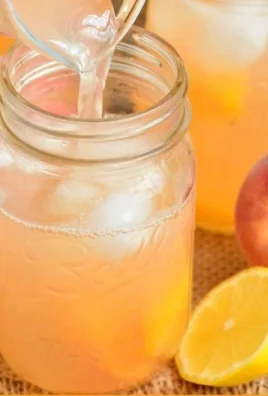A refreshing glass of homemade peach lemonade with fresh peach slices