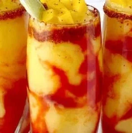 Delicious homemade Mangonada topped with chamoy and lime