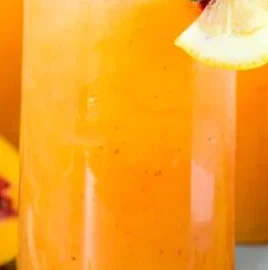 Refreshing peach lemonade in a chilled glass with slices of peach and lemon