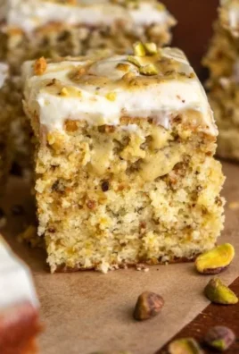 Slice of homemade pistachio cake with frosting and decorations