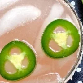 Refreshing Spicy Paloma cocktail with vibrant garnishes