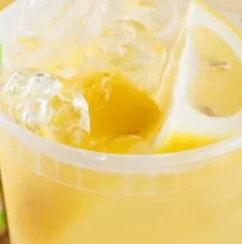 Refreshing State Fair Lemonade served in a cup at a summer fair.