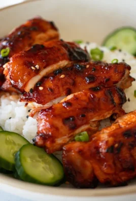 Sticky Honey Gochujang Chicken dish garnished with sesame seeds and green onions