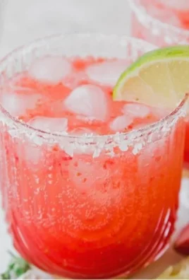 Strawberry Lime Mocktail Margarita served in a glass with fresh fruit garnish