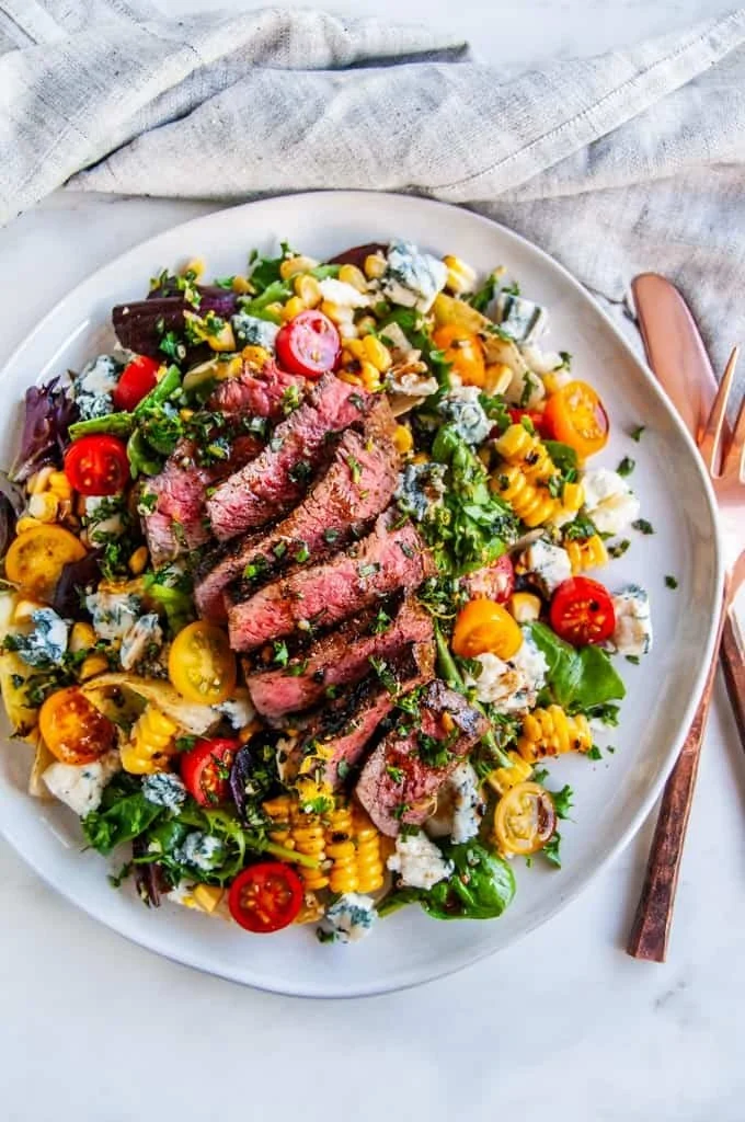 Balsamic Steak Gorgonzola Salad with Grilled Corn served on a plate