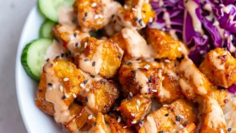 Crispy Bang Bang Tofu served with spicy sauce and fresh veggies