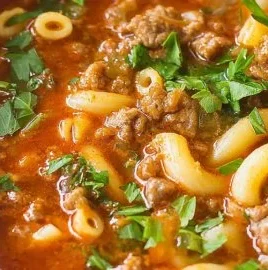 Bowl of delicious beef and macaroni soup with vegetables