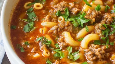 Bowl of delicious beef and macaroni soup with vegetables