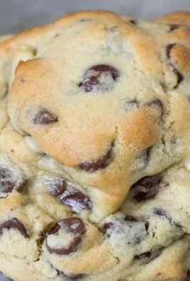 Delicious giant chocolate chip cookies on a plate with chocolate chunks