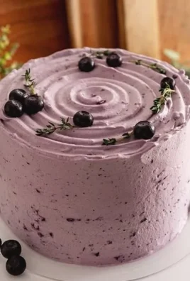 Delicious Blueberry Chiffon Cake topped with fresh blueberries and cream