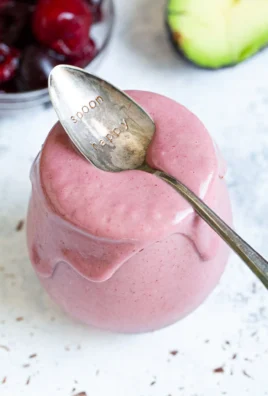 Cherry Avocado Smoothie served in a glass with fresh ingredients