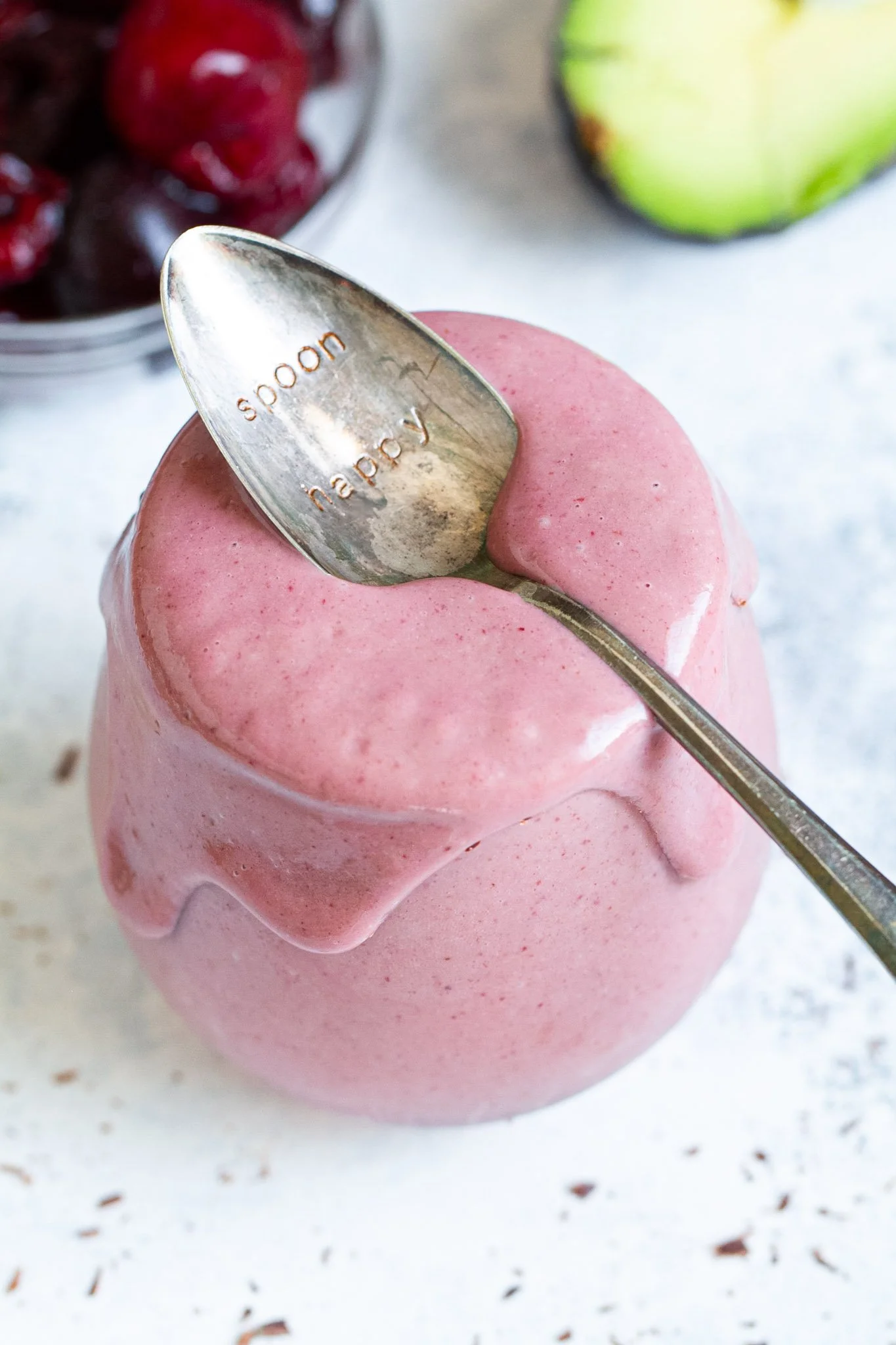 Cherry Avocado Smoothie served in a glass with fresh ingredients