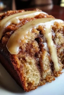 Delicious cinnamon roll banana bread with swirl topping on a wooden table
