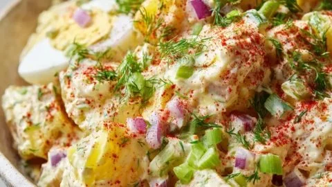 Classic creamy potato salad served in a bowl at a summer cookout