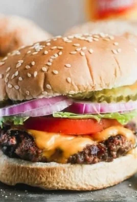 Delicious classic juicy hamburger with fresh toppings on a sesame seed bun