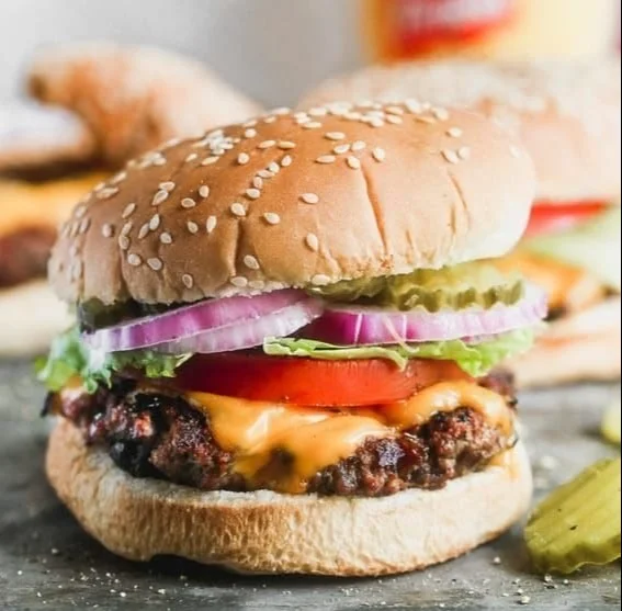 Delicious classic juicy hamburger with fresh toppings on a sesame seed bun