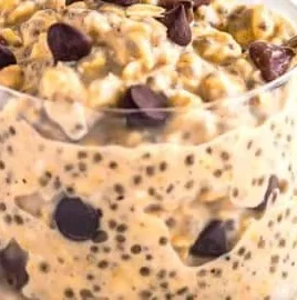Bowl of cookie dough overnight oats topped with chocolate chips and nuts