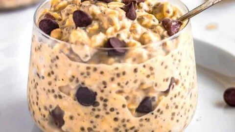 Bowl of cookie dough overnight oats topped with chocolate chips and nuts
