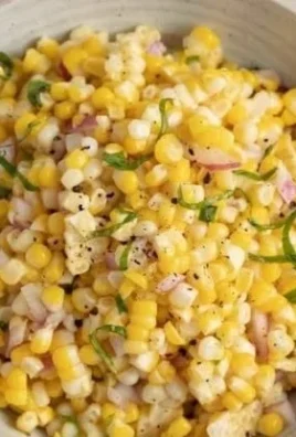 Colorful bowl of fresh corn salad with vegetables and dressing